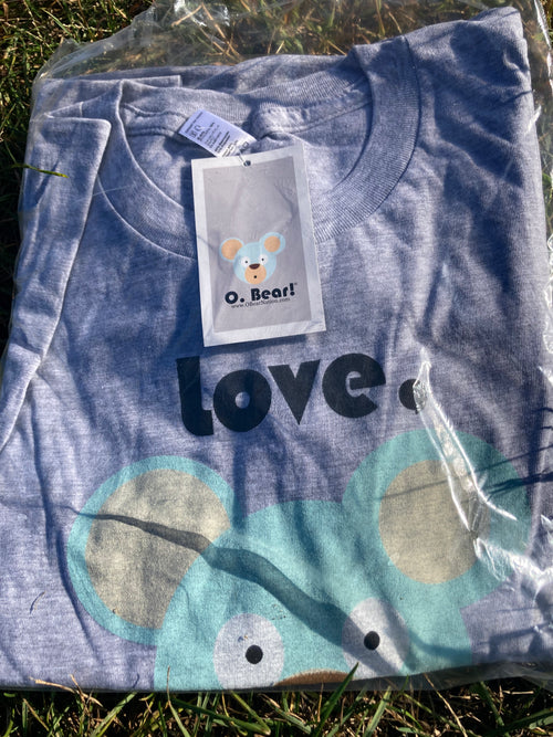 Gray t-shirt with 'Love, O. Bear!' and bear design, on grass