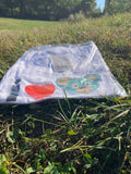 Packaged O. Bear t-shirt with cartoon designs on grass